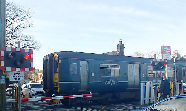 Train at the level crossing at Quintrell Downs